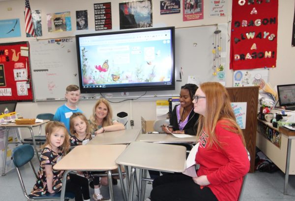 English teacher Julianne Spitalieri helps her children with some interview questions posed by journalism students Olivia Thomasson and Adryanna Cottemond
